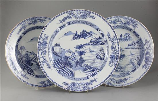 Three matching Chinese blue and white chargers, decorated lake scenes with pavilions and mountains,